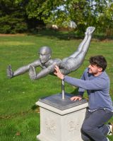 The Leap of Faith Contemporary Garden Statue With a Man Crouched to the Side of it for Scale