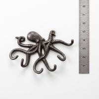 The Mariner Octopus Wall-Mounted Coat Hook on a White Background next to a Steel Ruler for Scale - Digital Illustration