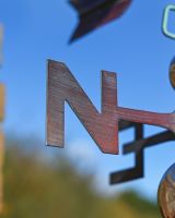 The Mariner’s Reach Sea Turtle Verdigris Copper Weathervane Showing a Close up of the Directional Lettering