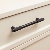 The Medium Half Knurled Cabinet Pull Handle in Aged Bronze on a Cream Set of Draws in a Modern Interior - Digital Illustration