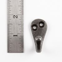 The Mini Single Robe Hook in Cast Antique Iron - 40mm On a White Background  next to a Ruler for Scale - Digital Illustration