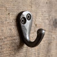 The Mini Single Robe Hook in Cast Antique Iron - 40mm Shown Mounted on a Wooden Board - Digital Illustration