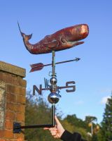 The Moby the Whale Verdigris Copper Weathervane with a Hand in Shot for Scale