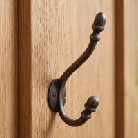 The Regency Oval Backplate Acorn Hook - 130mm Shown on the Back of a Timber Door - Digital Illustration