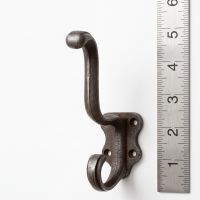 The Schoolhouse Heavy Duty Cast Iron Coat Hook on a White Background next to a Steel Ruler for Scale - Digital Illustration