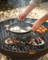 The Set of 3 Kadai Iron BBQ Skillet Pan Set Shown Being Placed onto a Kadai Bowl With a Grill - Digital Illustration