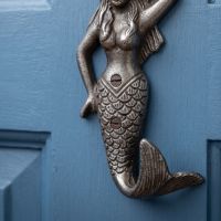 The Siren Mermaid Cast Antique Iron Wall Coat Hook - 145mm Showing a Close up of the Lower Part of the Mermaid and the Tail Shaped Hook - Digital Illustration