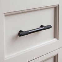 The Small Half Knurled Cabinet Pull Handle in Matt Black Fitted to a Kitchen Drawer thats been Painted White - Digital Illustration