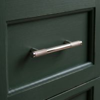 The Small Half Knurled Cabinet Pull Handle in Polished Nickel on a Forest Green Wooden Drawer in a Period Home - Digital Illustration