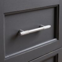 The Small Half Knurled Cabinet Pull Handle in Satin Chrome Shown Close Up on a Grey Kitchen Drawer - Digital Illustration