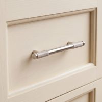 The Small Half Knurled Cabinet Pull Handle in Satin Stainless Steel On a Cream Coloured Drawer in a Modern kitchen - Digital Illustration