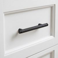The Small Knurled Cabinet Pull Handle in Matt Black on a White kitchen Drawer - Digital Illustration