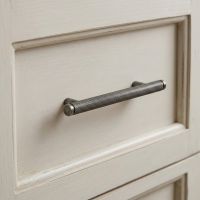 The Small Knurled Cabinet Pull Handle in Pewter Displayed on a Kitchen Drawer in a Cream Colour - Digital Illustration
