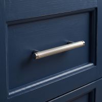 The Small Knurled Cabinet Pull Handle in Polished Nickel Displayed in a Modern Home on a Wooden Drawer - Digital Illustration