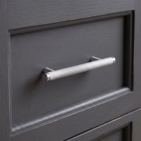 The Small Knurled Cabinet Pull Handle in Satin Chrome Mounted on a Grey Drawer - Digital Illustration