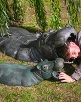 The Small Zambezi Submerged Hippo Garden Sculpture Showing a Man with his Head inside the Large Version Laughing