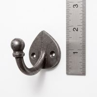 The Spade Backplate Single Wall Hook - 65mm on a White Background next to a Steel Ruler for Scale - Digital Illustration