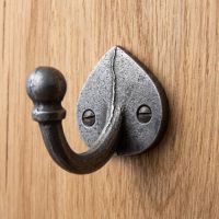 The Spade Backplate Single Wall Hook - 65mm Shown on a Wooden Panel Wall - Digital Illustration