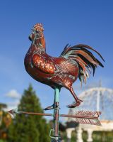 The Striding Rooster Verdigris Copper Weathervane Shown from the Side in a Heritage Garden