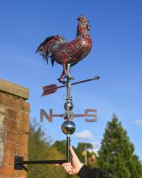 The Striding Rooster Verdigris Copper Weathervane Shown with a Hand in Shot for Scale