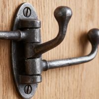 The Swivel Triple Arm Cast Iron Coat Hook 75mm x 100mm Showing a Close up of the Swinging Arm Mechanism - Digital Illustration