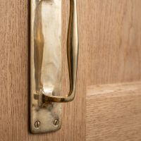 The Taproom Integral Plate Polished Brass Door Pull - 300mm Showing a Close up of the Screw Attachment Points - Digital Illustration