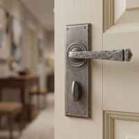 The Thornton Pewter Finish Lever Handle With Thumb Lock Mounted on a Classic Cream Coloured Door - Digital Illustration