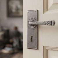 The Thornton Simple Contemporary Pewter Lever Handle With Keyhole on a Cream Door in a Modern Home - Digital Illustration
