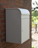 The "Titan" Medium Wall Mounted Parcel Box Steel in Cream Shown from the Side Whilst Mounted to a Brick Wall