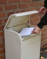 The "Titan" Medium Wall Mounted Parcel Box Steel in Cream Shown with a Hand Posting a Letter