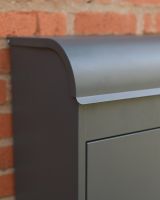 The "Titan" Medium Wall Mounted Parcel Box Steel in Grey Showing a Close up of the Curved Lid