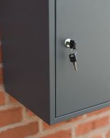 The "Titan" Medium Wall Mounted Parcel Box Steel in Grey Showing a Close up of the key Lock