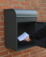 The "Titan" Medium Wall Mounted Parcel Box Steel in Grey Showing a Letter Being Retrieved from Inside