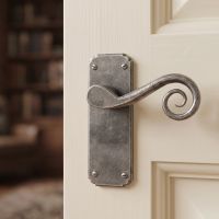 The Ververt Monkeytail Lever Latch Set Pewter on a Classic Cream Coloured Door - Digital Illustration