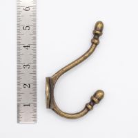 The Victorian Hat and Coat Hook in Antique Copper - 130mm On a White Background  next to a Ruler - Digital Illustration