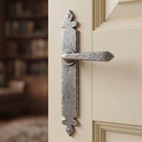 The Vittoria Pewter Tudor Sprung Lever Latch Set Shown Close up on a Cream Door in a Traditional Home - Digital Illustration