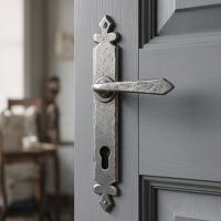The Vittoria Pewter Unsprung Tudor Espagnolette Lever Set on an Open Grey Door in a Home - Digital Illustration