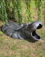 The Zambezi Submerged Hippo Garden Sculpture Shown on a Grassy Lawn in a Sunny Garden
