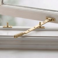 The 10" Satin Brass "Royale" Four Pin Window Stay Fitted on a Traditional White Painted Window - Digital Illustration The 10" Satin Brass "Royale" Four Pin Window Stay Fitted on a Traditional White Painted Window - Digital Illustration