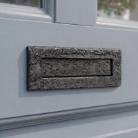 The 10½" Traditional Black Iron Simplistic Door Letter Plate Mounted on a Sunny Blue Front Door - Digital Illustration