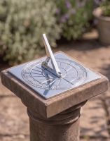 The 120mm Bright Chrome "Rising Sun" Sundial Fixed onto a Stone Garden Pillar on a Sunny Day - Digital Illustration