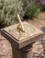 The 120mm Polished Brass "Rising Sun" Sundial Fitted onto a Stone Plinth in a Sunny Garden - Digital Illustration The 120mm Polished Brass "Rising Sun" Sundial Fitted onto a Stone Plinth in a Sunny Garden - Digital Illustration
