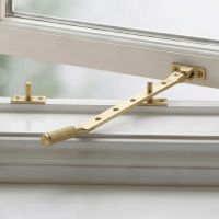 The 12" Satin Brass "Royale" Five Pin Window Stay Fitted on a Classic White Window - Digital Illustration The 12" Satin Brass "Royale" Five Pin Window Stay Fitted on a Classic White Window - Digital Illustration