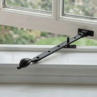 The 12" Traditional Black Iron Window Casement Stay With Petal Shaped Handle Fitted on an Open White Window - Digital Illustration The 12" Traditional Black Iron Window Casement Stay With Petal Shaped Handle Fitted on an Open White Window - Digital Illustration