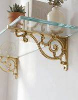 The 12 x 21cm "Luciano" Ornate Scroll Brass Wall Bracket Mounted on a White Wall in a Modern Home Seen from Underneath - Digital Illustration The 12 x 21cm "Luciano" Ornate Scroll Brass Wall Bracket Mounted on a White Wall in a Modern Home Seen from Underneath - Digital Illustration