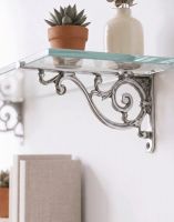 The 12 x 21cm "Luciano" Ornate Scroll Bright Chrome Wall Bracket Mounted on a White Wall in a Modern Home Shown from the Side - Digital Illustration 