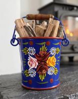 The 14cm Small Blue Narrowboat Hand Painted Bucket used for Holding Kindling Next to a traditional Log Burner Stove - Digital Illustration The 14cm Small Blue Narrowboat Hand Painted Bucket used for Holding Kindling Next to a traditional Log Burner Stove - Digital Illustration