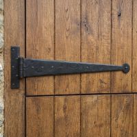 The 18" Black Round Ended Tee Hinges on a Wooden Stable Door in a Courtyard - Digital Illustration
