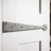 The 18" Pewter Traditional Hinge Front Fitted to a White Timber Door inside a Modern Home - Digital Illustration