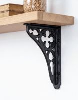 The 18 x 13cm Black Cast Iron Coalbrookdale Shelf Bracket Mounted on a Neutral Coloured Wall in a Modern Home being used as a Wall Bracket - Digital Illustration